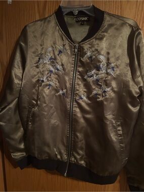 Cosmic Olive Green Embroidered Bomber Jacket. Embroidered cranes herons storks.